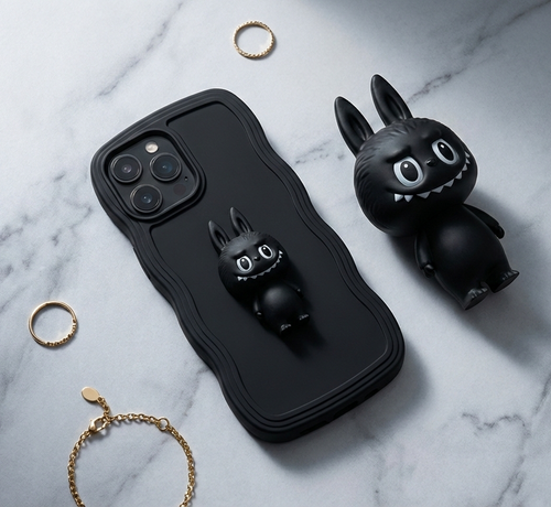 Black phone case with a cartoon character on a marble surface